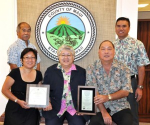 Photo Courtesy: County of Maui. L-R: Budget Director Fred Pablo (standing); Helene Kau, Assistant Budget Director; Mayor Charmaine Tavares; Ty Yoshimi, Accounting System Administrator; Kalbert Young, Finance Director (standing).