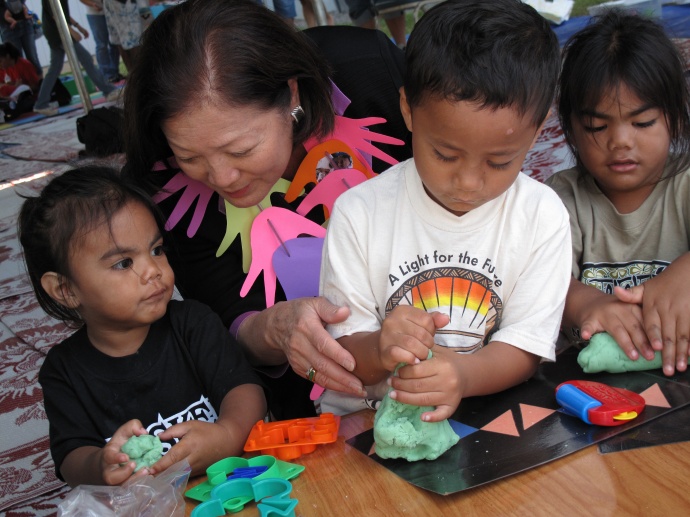 Congresswoman Hirono assists young children at the Tutu and Me traveling preschool program.  File photo courtesy, Office of Rep. Mazie Hirono.