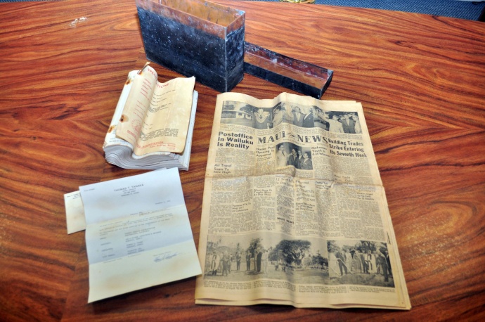 The three items that were found in the time capsule – a Maui News, a letter from the contractor, and blueprints of the post office.
