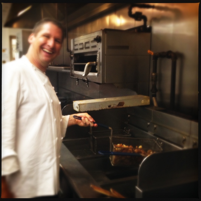Executive Chef Marc McDowell cheerfully agrees to relive his days as a fry boy for a photo op. Photo by Vanessa Wolf