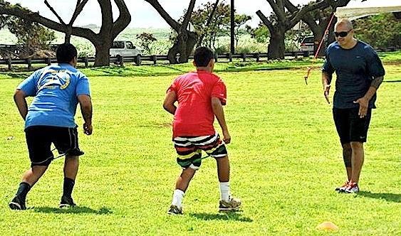 Kaluka Maiava works with a pair of Maui athletes at last year's HardNaks High-Performance Speed Camp. File football by Rodney S. Yap.