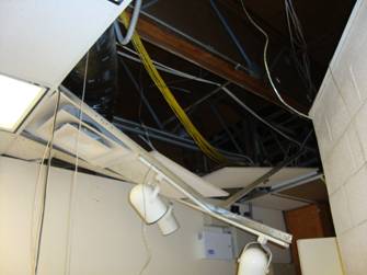 Damage to ceiling panel, lighting, and wiring of the prisoner processing room.  Courtesy photo.