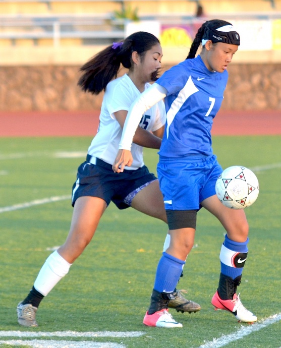 Maui High's Tiare Lucas fends off Kamehameha Maui's Kaylee Correa during second-half action Tuesday. Photo by Rodney S. Yap.