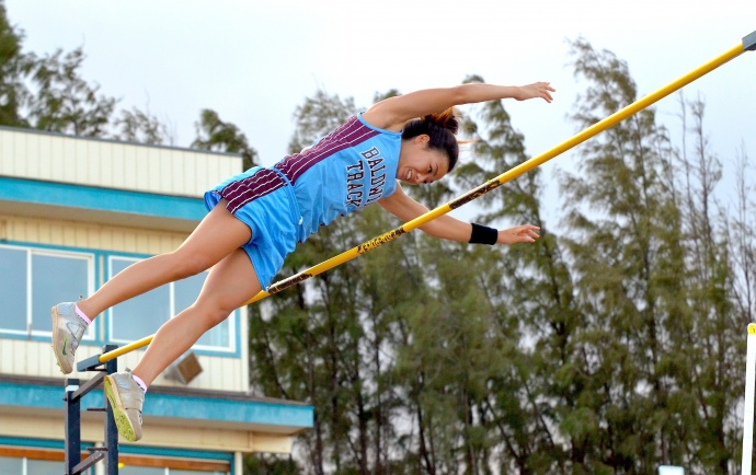 Baldwin's Amber Kozaki completes her record-breaking pole vault of 13 feet. Photo by Rodney S. Yap.