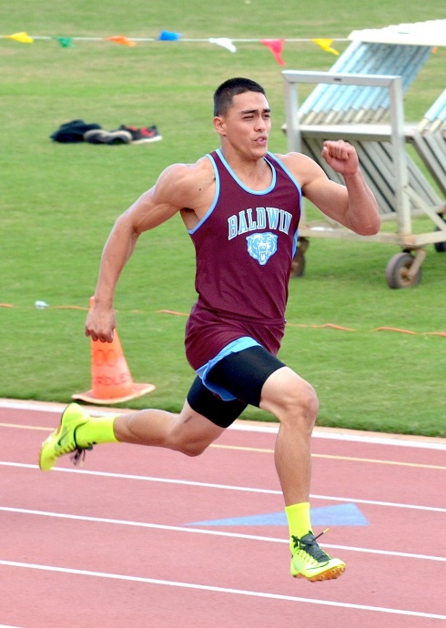 Baldwin High School's Keelan Ewaliko posted two of the all-time fastest marks in the 100 and 200 Friday at the Honolulu Marathon Invitational. Photo by Rodney S. Yap.