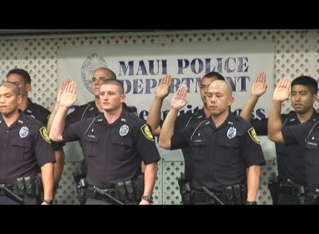 Members of the Maui Police Department's 77th Recruit Class take the officer's oath during graduation. Photo by Wendy Osher.