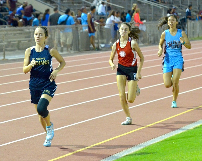 St. Anthony's Rebekah Hallsten leads Lahainaluna's Kailey Sager and Baldwin's Ellissa Bio in the girls varsity 800 Friday. Photo by Rodney S. Yap.