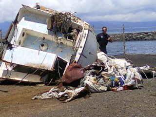 Best Revenge debris prepared for removal to central Maui landfill.  Ed Underwood, DOBOR administrator inspects the debris pile. Photo courtesy Maui district boating office.