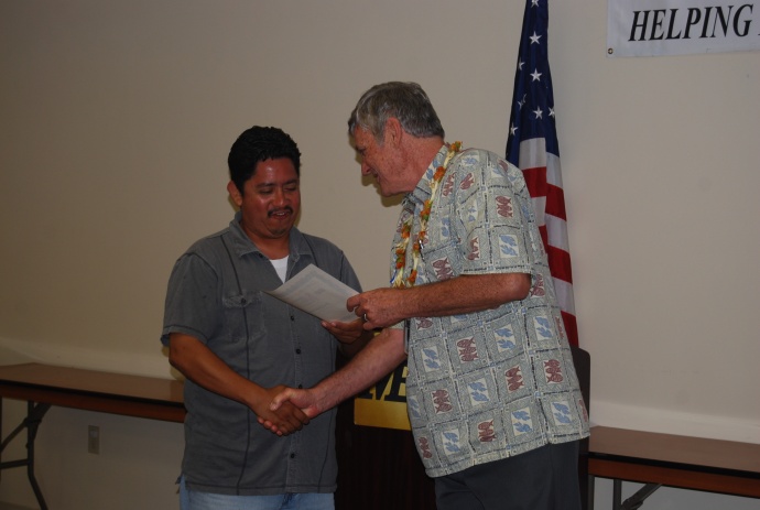 Graduate Jose Castellanos receives a certificate of achievement from Craig Swift, the director of the Maui Economic Opportunity's Business Development Center. Courtesy photo. 