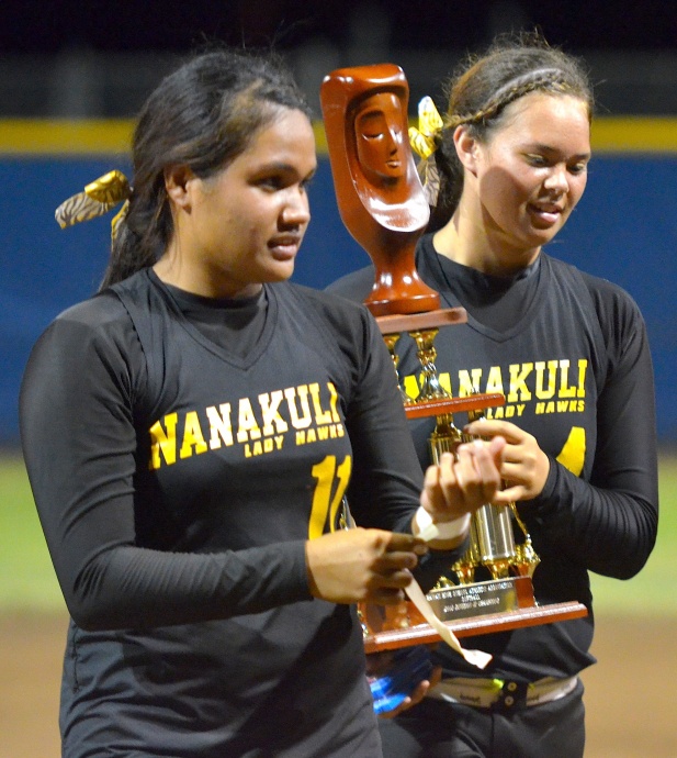 Nanakuli's Ashley Van Gieson (right) and Brayann Meyers hold the girls Division II state softball championship trophy following their 5-4 win over Saint Francis on Friday at the Patsy Mink Field. Photo by Rodney S. Yap.