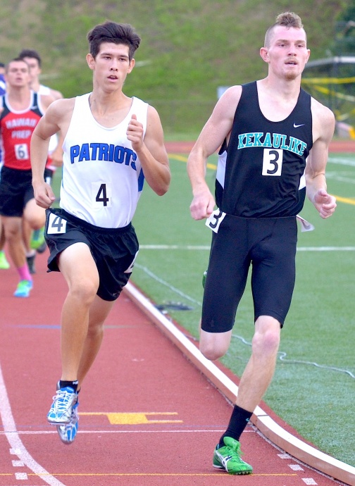 King Kekaulike's Keegan Gregg leads the boys 800 over Christian Academy's Michael Chin (left) after the first lap. Chin used a strong kick to win the race in 1:53.00, while Gregg finished third in 1:57.23. Photo by Rodney S. Yap.