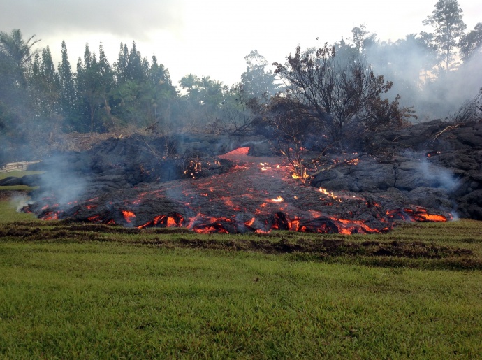 A breakout occurs from an inflated lobe of the June 27th lava flow on Sunday morning, November 2, 2014.  This is upslope of the stalled leading edge.  Photo courtesy USGS/ Hawaiian Volcano Observatory. File photo Nov. 2014.