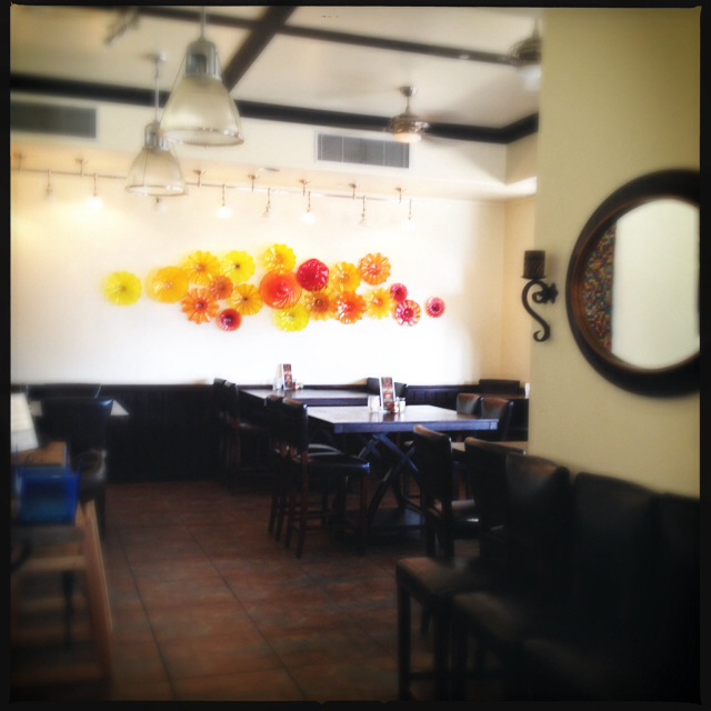 The restaurant's dining area features a striking art piece from local glass artist, Rick Strini. Photo by Vanessa Wolf