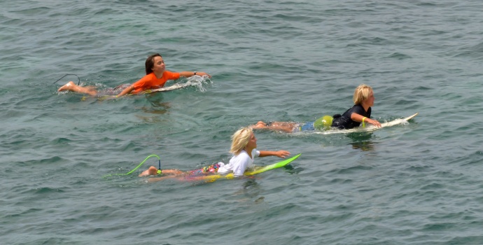 Three surfers paddle out before the start of their heat Saturday at Hookipa Beach Park. Photo by Rodney S. Yap.