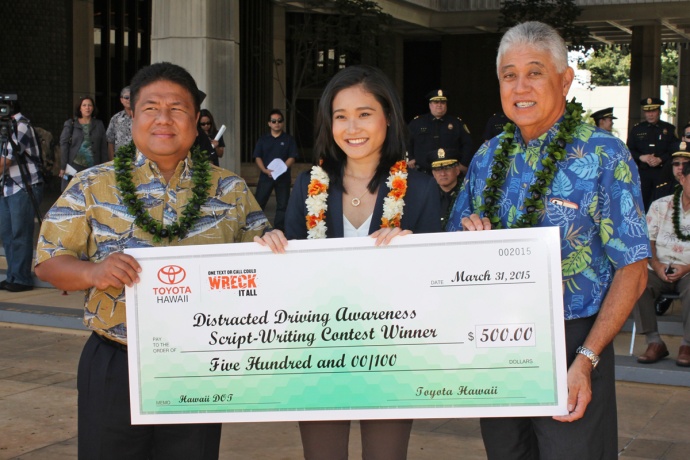 HDOT hosted a competition for students from UH Manoa’s Dept. of Communications and the Academy for Creative Media. Students submitted original concepts and scripts for a new public service announcement (PSA) focusing on distracted driving.  Contest winner Haruna Yamanaka (center) was presented with a $500 check by Glenn Inouye of Servco Pacific (right) and HDOT Deputy Director Jade Butay (left) during today’s event. Her winning concept and script will be professionally produced and broadcast on television and in movie theaters statewide later this summer. 