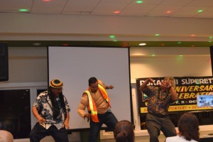 Pukalani Superette 60th Anniversary celebration. Owners dancing with Emcee Kaleo Pilanca.