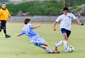 Kamehameha Maui's Jake Mateaki (5) tries to dribble to past Baldwin defender Hayden Hawes during second-half action Friday at War Memorial Stadium. Photo by Rodney S. Yap.