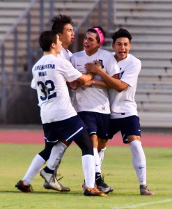 Kamehameha Maui's Paytin Ayau (headband) is congratulated by teammates, includig Kealaula Keli’ikoa (right) and Cy Ornellas (left), after scoring the tying goal in the 78th minute Friday against Baldwin at War Memorial Stadium. The matched ended in a 3-3 tie. Photo by Rodney S. Yap.