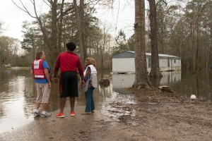 Wednesday March 16, 2016. McClain, Mississippi. Red Cross volunteers Lil Doody and Fran Walker console Davrion Hartfield, a resident of McClain, MS as they look out on flooded homes. Photo by Shannon Toombs/ American Red Cross