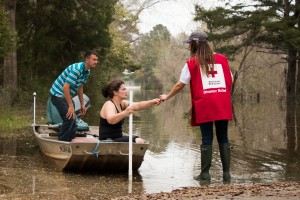 Wednesday March 16, 2016. McClain, Mississippi. Suzy Cooley and Aaron Cooley brave the flood waters on a fishing boat in McClain, MS.  Red Cross volunteer, Sarah Basel, notifies them of a nearby Red Cross Point of Contact. Photo by Shannon Toombs/ American Red Cross
