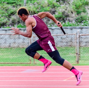 Baldwin's La'akea Kahoohanohano-Davis explodes out of the starting blocks running the first leg of the boys 4 x 100 relay. Photo by Rodney S. Yap.