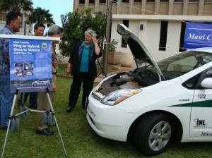 Mayor Tavares looks under the hood of the County's new plug-in hybrid Toyota Prius.