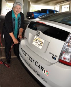 Maui Mayor Charmaine Tavares plugs in the county's Hybrid electric-car collecting data on its usage and performance.  Photo courtesy, County of Maui.  