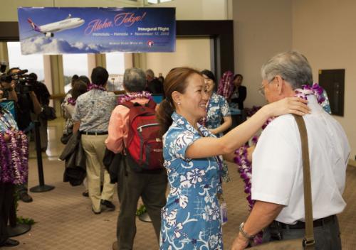 Passengers on Hawaiian Airlines' inaugural flight from Honolulu to Tokyo's Haneda Airport were presented with a fresh flower lei upon boarding. Hawaiian is offering daily, nonstop service between the two destinations, the only U.S. carrier to do so. (PRNewsFoto/Hawaiian Airlines, Inc. by John De Mello) 