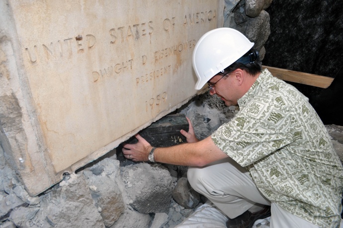 Managing Director Keith Regan removing the time capsule below the cornerstone.