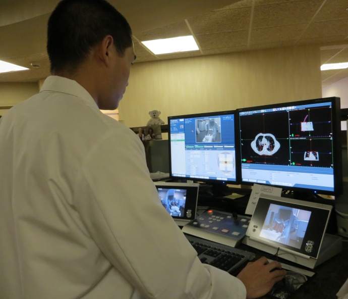 Radiation oncologist Dr. Clayton Chen oversees a new and first-timeoffering of a treatment called Stereotactic Body Radiation Therapy at thePacific Cancer Institute of Maui. In this photo, Chen reviews cat scansproduced on the cancer center's TrueBeam STx to confirm accuratepositioning before delivery of the radiation treatment.
