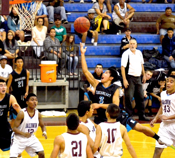 King Kekaulike point guard Jansen Agapay drives to the basket en route to a 3-point play late in the game Thursday night against Baldwin. Photo by Rodney S. Yap.