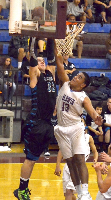 Baldwin's Teva Eldredge (43) battles King Kekaulike's Jacob Havron under the basket Tuesday night at Baldwin gym. Na Alii clinched the 2013 MIL boys Division I championship with a 42-36 triumph. Photo by Rodney S. Yap.