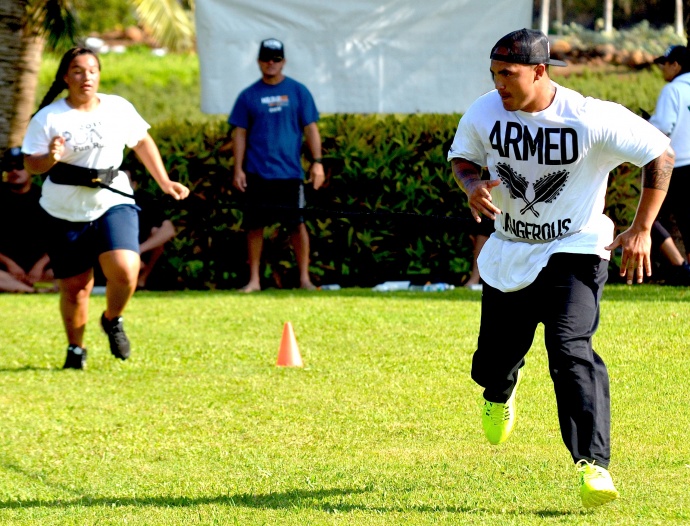 NFL free-agent linebacker Kaluka Maiava pulls 13-year-old Kayla Maka during speed and agility drills Saturday at the HardNaks High-Performance Speed Camp. Photo by Rodney S. Yap.