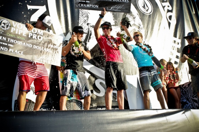 Hawaii's John John Florence (red) celebrates winning his third consecutive Volcom Pipe Pro Saturday at Banzai Pipeline. Hana's Ola Eleogram (black) prepares the champagne for Florence. The Maui surfer finished fourth in the finals worth $5,500. Photo by Tom Carey / VolcomPipePro.com.