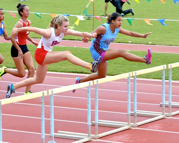 Seabury Hall's Christy Fell battles Baldwin's Raeana Anguay in the girls 100 hurdles Saturday. Fell won a close race in a time of 16.14 seconds to Anguay's 16.15. Photo by Rodney S. Yap.