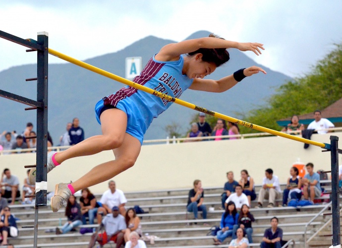 Baldwin's Amber Kozaki looks down at the pole vault pit below her after clearing 12 feet, 1 inch Friday. Photo by Rodney S. Yap. 