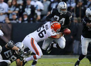 Former Cleveland linebacker Kaluka Maiava (56) is shown tackling the Raiders' Juron Criner in the second quarter in Oakland, Calif., on Sunday, Dec. 2, 2012. Photo by Nhat V. Meyer.