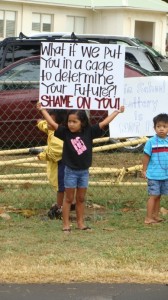 Keiki were among those holding signs at a demonstration this morning that was organized in protest of the planned lottery for placement in the Hawaiian language immersion kindergarten at Pāʻia Elementary School on Maui. Photo by Wendy Osher.