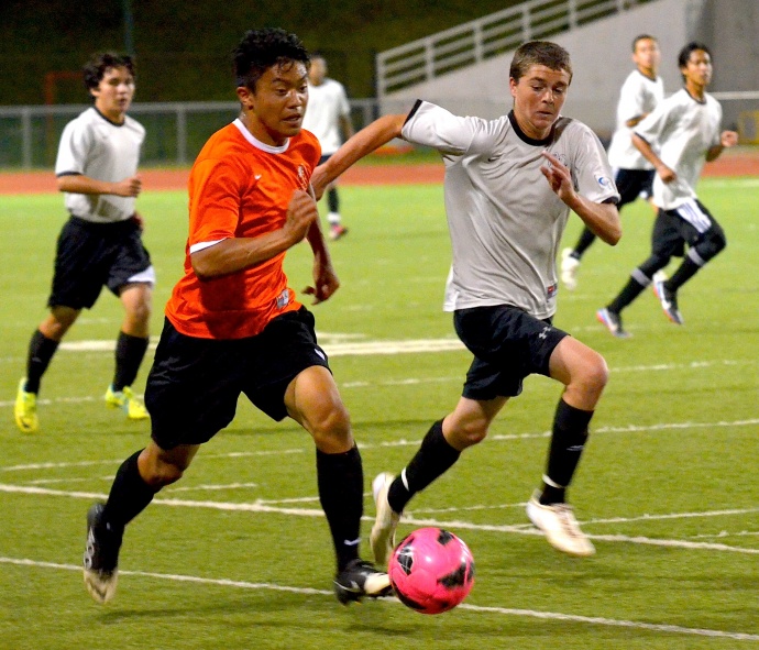 Bryant Kubo (left) dribbles up the line, looking for a passing lane, representing West Virginia, Friday at 