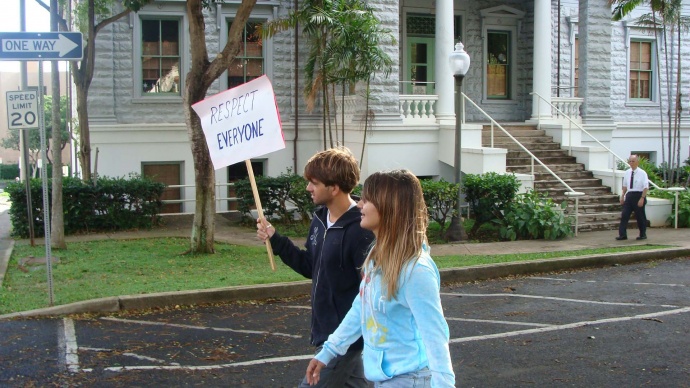 Unnamed individuals carrying signs during a Martin Luther King Jr. march on Maui two years ago. File photo 2011 by Wendy Osher. Note: The complaint was filed in reference to the December 2012 event, which occurred along the same route the following year.