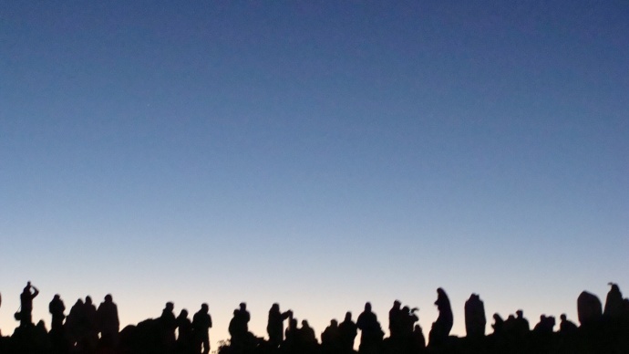 Haleakalā Visitor Center. Silhouettes of sunrise watchers line the horizon.  People Pōhaku, photo by Wendy Osher.