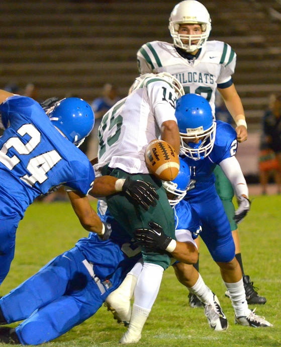 Maui High's Andre Pierman forces the ball lose on this tackle. Photo by Rodney S. Yap.