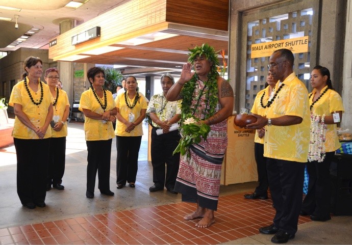 Roberts Hawaiʻi employees gather for the blessing of their new Maui Airport Shuttle service, led by Kahu Kimokeo Kapahulehua at the main lobby of Kahului Airport. Courtesy photo, Lulu Unemori.
