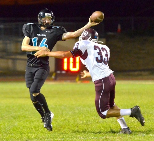 King Kekaulike quarterback Ryley Widell tries to deliver this pass as Baldwin's Chase Kuluhiwa-Rodrigues applies defensive pressure. Photo by Rodney S. Yap.