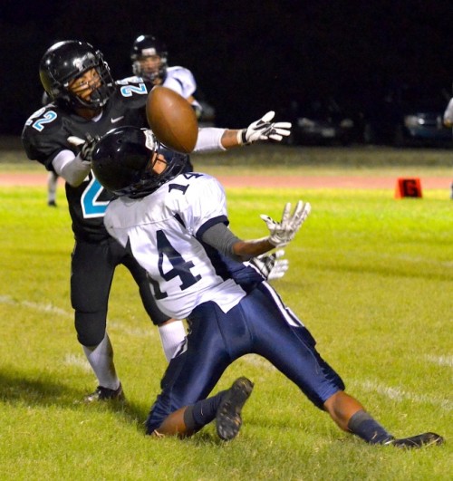 King Kekaulike's Jacob Ramos (22) breaks up this pass intended for Kamehameha Maui's Keoni Keanini (14) in the second half. Photo by Rodney S. Yap.
