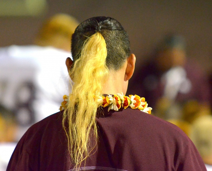 Farrington High School head coach Randall Okimoto sports the blond ponytail in tribute to former Governors' player Dayne Ortiz. Photo by Rodney S. Yap.
