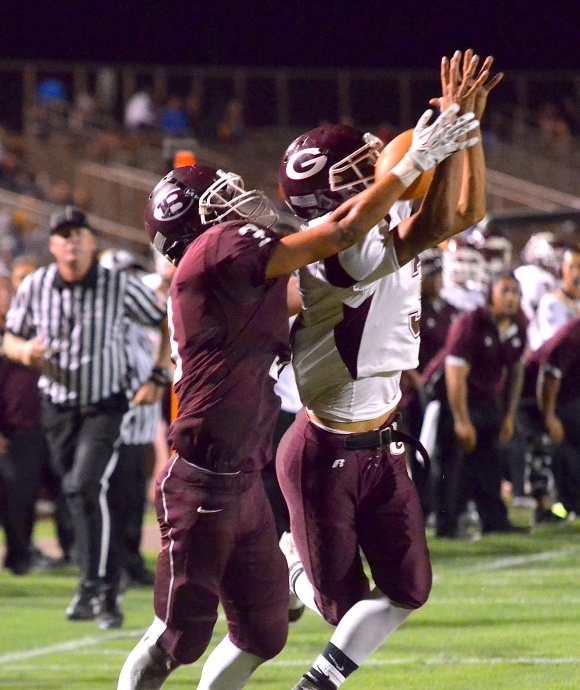 Farrington’s Roger Boyd intercepts this pass intended for Baldwin’s Jeremiah Badillo (3) late in the fourth quarter Friday at War Memorial Stadium. Farrington beat Baldwin 21-3. Photo by Rodney S. Yap.