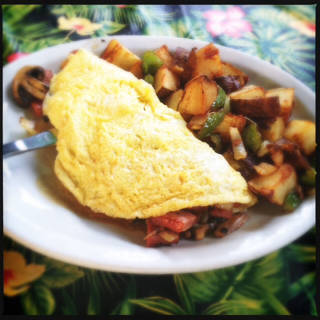 The Omelet arrived with some slightly undercooked home fries. Photo by Vanessa Wolf
