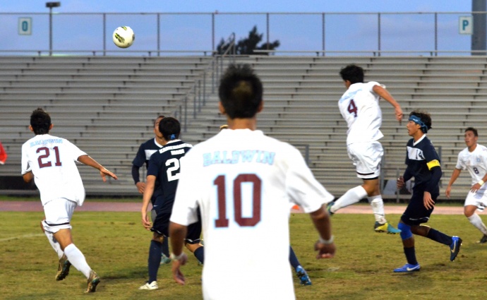 Baldwin's Ricky Casco (4) uses his head to assist teammate Matt Foronda (21) on this play, which results in the Bears' second goal of the match. Photo by Rodney S. Yap.