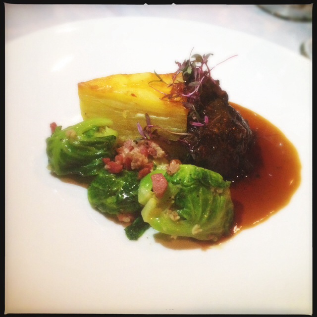 Braised veal cheeks and pancetta Brussels sprouts from a previous Makena Beach event. Photo by Vanessa Wolf